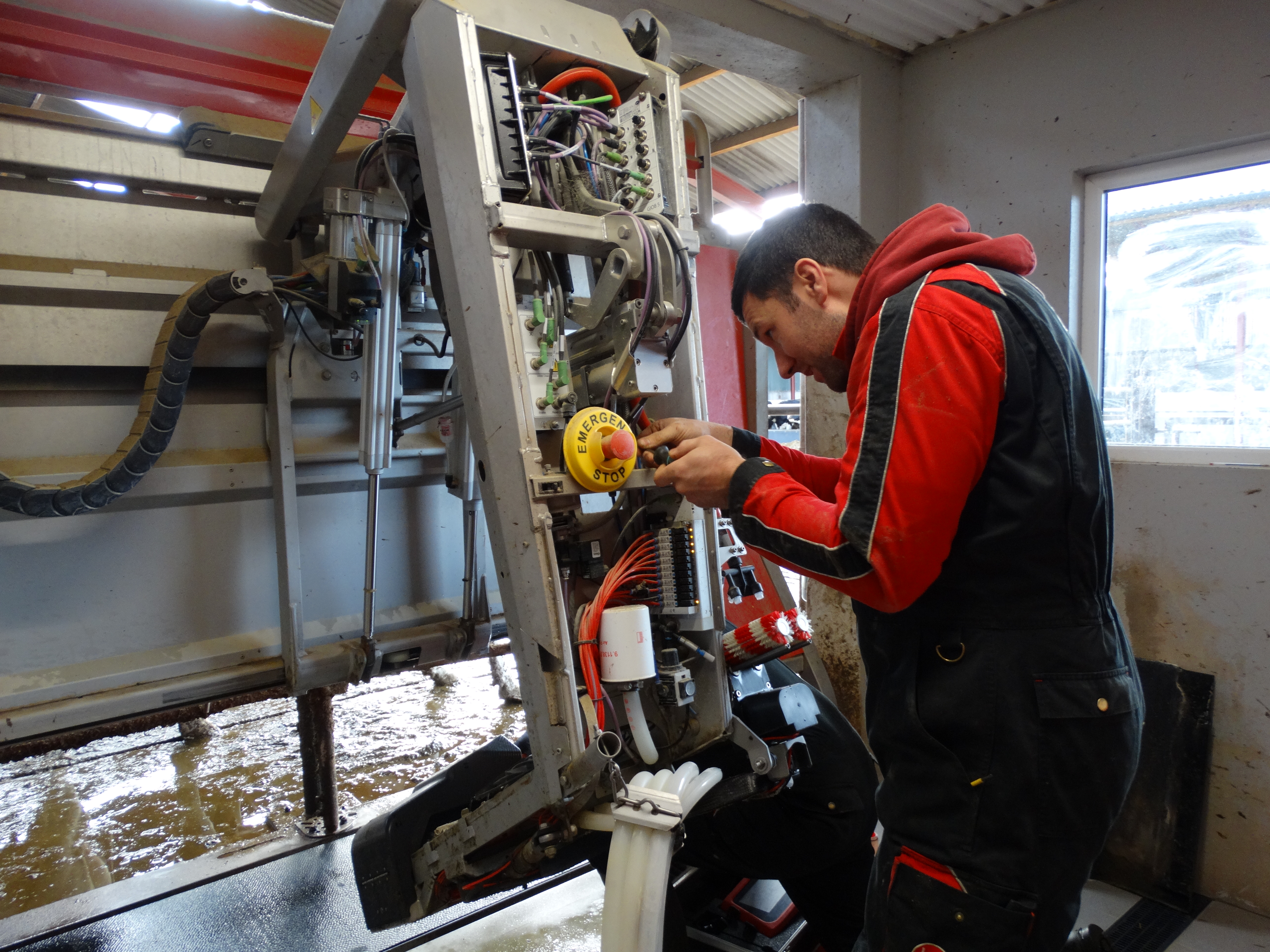 Service technician in the barn testing Lely Vector